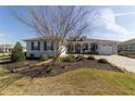 Beautifully landscaped front yard with a charming home featuring blue shutters at 8864 Sw 85Th Loop, Ocala, FL 34481