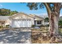 Beautiful home featuring a two-car garage, manicured lawn, and a welcoming facade at 9064 Sw 91St Cir, Ocala, FL 34481