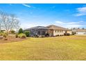 Spacious backyard featuring a screened-in patio, perfect for outdoor entertaining and relaxation at 9085 Sw 89Th Loop, Ocala, FL 34481