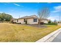 Well-maintained home with a lush lawn, mature trees, and manicured landscaping at 9085 Sw 89Th Loop, Ocala, FL 34481