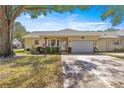 Charming single-story home featuring a large driveway, attached garage, and well-maintained landscaping at 9335 Sw 85Th Ter # A, Ocala, FL 34481