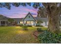 Inviting single-story home featuring an inviting porch area set against a vibrant sunset backdrop at 9348 Sw 82Nd Ter # C, Ocala, FL 34481