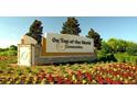 On Top of the World Community sign with beautiful floral landscaping at 9652 Sw 84Th Ter # C, Ocala, FL 34481