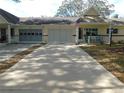 Well maintained single story home with wide driveway, and American flag at 9652 Sw 84Th Ter # C, Ocala, FL 34481