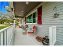 Cozy front porch with seating, perfect for relaxing and enjoying the neighborhood views at 10821 Sw 87Th Ter, Ocala, FL 34481