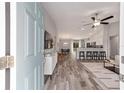 Open-concept living room featuring modern furnishings, hardwood floors, and a ceiling fan at 11 Locust Trak, Ocala, FL 34472