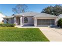 Well-maintained one-story home with lush lawn, two-car garage, and appealing architectural details at 11625 Sw 71St Cir, Ocala, FL 34476