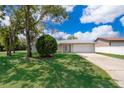 Charming single-story home with a well-maintained lawn and a two-car garage at 18 Fir Trail Pass, Ocala, FL 34472