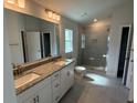Bathroom featuring double sinks, granite countertops and a glass enclosed shower at 2150 Nw 23Rd Loop, Ocala, FL 34475