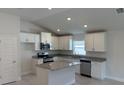 Modern kitchen featuring stainless steel appliances, granite countertops and white cabinetry at 2150 Nw 23Rd Loop, Ocala, FL 34475