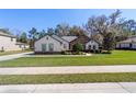 Lovely single-Gathering house with a stone facade, lush green lawn, and mature landscaping at 4103 Se 10Th Ave, Ocala, FL 34480