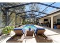 Relaxing screened-in pool with comfortable lounge chairs and plenty of space for entertaining guests at 4103 Se 10Th Ave, Ocala, FL 34480