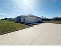 A side view of this new home highlighting the ample yard, driveway, and attached garage at 4524 Sw 110Th St, Ocala, FL 34476