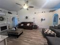 Open living room with vaulted ceilings, wood floors, and neutral tones at 4580 Sw 110Th Ln, Ocala, FL 34476