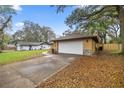 Exterior shot showing the side of the house and detached garage at 5205 Ne 3Rd St, Ocala, FL 34470