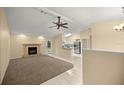 Inviting living room with a cozy fireplace, ceiling fan, and easy access to the kitchen at 5205 Ne 3Rd St, Ocala, FL 34470