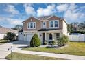 Charming two-story home with three-car garage, manicured lawn, and a welcoming exterior design at 5417 Sw 49Th Ave, Ocala, FL 34474