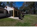 Back view of the home showing porch and yard at 7972 Midway Drive Ter # O103, Ocala, FL 34472