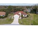 Aerial view of a single Gathering home with manicured landscaping and a tile roof in a quiet neighborhood at 8223 Sw 113Th Ln, Ocala, FL 34481