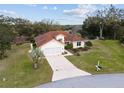 Beautiful single Gathering home with tile roof, attached garage, driveway, and a nicely landscaped yard at 8223 Sw 113Th Ln, Ocala, FL 34481