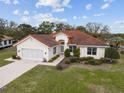 Charming single Gathering home with red tile roof, attached garage, and a beautifully landscaped front yard at 8223 Sw 113Th Ln, Ocala, FL 34481