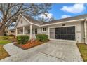 Inviting exterior showcases a well-manicured lawn and a screened garage at 8645 Sw 94Th Ln # A, Ocala, FL 34481