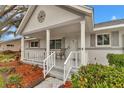 Covered front porch with white railing, ideal for relaxation at 8645 Sw 94Th Ln # A, Ocala, FL 34481