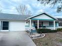 Single-story home boasts a well-maintained lawn and a charming, covered front porch at 8685 Sw 94Th Ln # B, Ocala, FL 34481