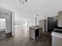 Updated kitchen featuring light wood floors, an island, and neutral walls at 11745 Nw 15Th Lane, Ocala, FL 34482