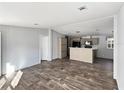 Open-concept living room featuring updated finishes, a kitchen view and light wood floor at 11745 Nw 15Th Lane, Ocala, FL 34482
