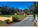 Charming single-story home with yellow stucco, red tile roof, and a well-manicured lawn at 1255 Ne 70Th St, Ocala, FL 34479