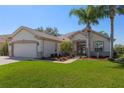 Charming single Gathering home with attached two car garage, manicured lawn, and mature landscaping at 13544 Se 89Th Terrace Rd, Summerfield, FL 34491