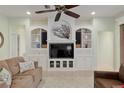 Bright living room featuring a built-in media center, a ceiling fan, tile flooring, and neutral paint at 13544 Se 89Th Terrace Rd, Summerfield, FL 34491