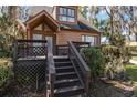 Attractive two-story home with a cozy front porch and wooden steps, enhanced by well-maintained landscaping and mature trees at 1621 Ne 2Nd St # 601, Ocala, FL 34470