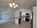Modern kitchen featuring stainless steel appliances, an island, and an open floorplan at 209 Sw Winding Hills Rd, Dunnellon, FL 34431