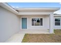 This home has a covered front porch, a blue front door and is freshly painted at 22 Juniper Drive Crse, Ocala, FL 34480