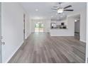 Open concept living room with gray wood-look floors and a kitchen with white cabinets at 22 Juniper Drive Crse, Ocala, FL 34480