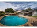 Sparkling pool and spa with brick patio, perfect for outdoor entertaining and relaxation at 4420 Ne 1St St, Ocala, FL 34470