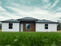 New construction home with a modern exterior design featuring a mix of white siding and wood accents at 4501 Sw 110Th Ln, Ocala, FL 34476