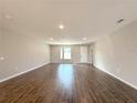 Spacious living room features wood-look tile flooring and a bright, airy feel with neutral paint at 4501 Sw 110Th Ln, Ocala, FL 34476