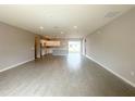 Open-concept living space featuring wood-look tile flooring and an adjacent kitchen at 4501 Sw 110Th Ln, Ocala, FL 34476