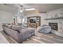 Comfortable living room features a cozy fireplace and stylish wood flooring at 5902 Sw 112Th Place Rd, Ocala, FL 34476