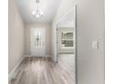 Light, airy entryway featuring wood-look flooring and views into other rooms of the home at 5910 Sw 111Th Place Rd, Ocala, FL 34476