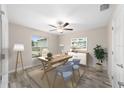 Well-lit office space with a ceiling fan, a large window, and neutral decor for a professional workspace at 5910 Sw 111Th Place Rd, Ocala, FL 34476