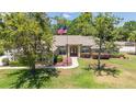 Ranch home featuring a well-manicured lawn and front walkway at 6279 Se 8Th Lane, Ocala, FL 34472