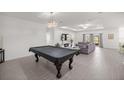 Open-concept living room featuring bright, neutral paint, tile floors, and tray ceiling at 7374 Sw 77Th Ave, Ocala, FL 34481