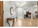 Elegant foyer with tile flooring, chandelier, and a decorative table, leading to the dining area at 8782 Sw 82Nd Court Rd, Ocala, FL 34481