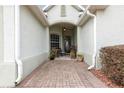 Inviting entryway with a decorative glass door and a cozy seating area on a brick walkway at 8782 Sw 82Nd Court Rd, Ocala, FL 34481