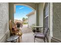 Charming porch with seating, offering a view of the brick walkway and manicured landscaping at 8782 Sw 82Nd Court Rd, Ocala, FL 34481