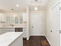 Bright kitchen features white cabinets, stainless steel appliances, and an island with quartz countertop at 9504 Sw 97Th Ln # B, Ocala, FL 34481